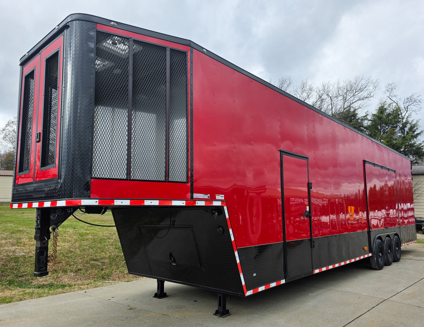 8.5x42 Red Gooseneck Enclosed Trailer Generator Cage with Rear Gullwing (3) 7000k Axles Front Left Side 