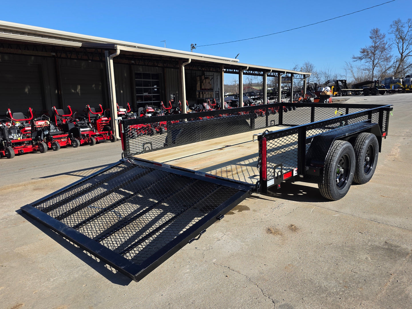 7' X 12' Straight Deck Utility Trailer 18IN Mesh Sides Double Axle 7K GVWR back right angled view picture with ramp down 