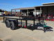 7' X 12' Straight Deck Utility Trailer 18IN Mesh Sides Double Axle 7K GVWR front left angled view picture with ramp down 