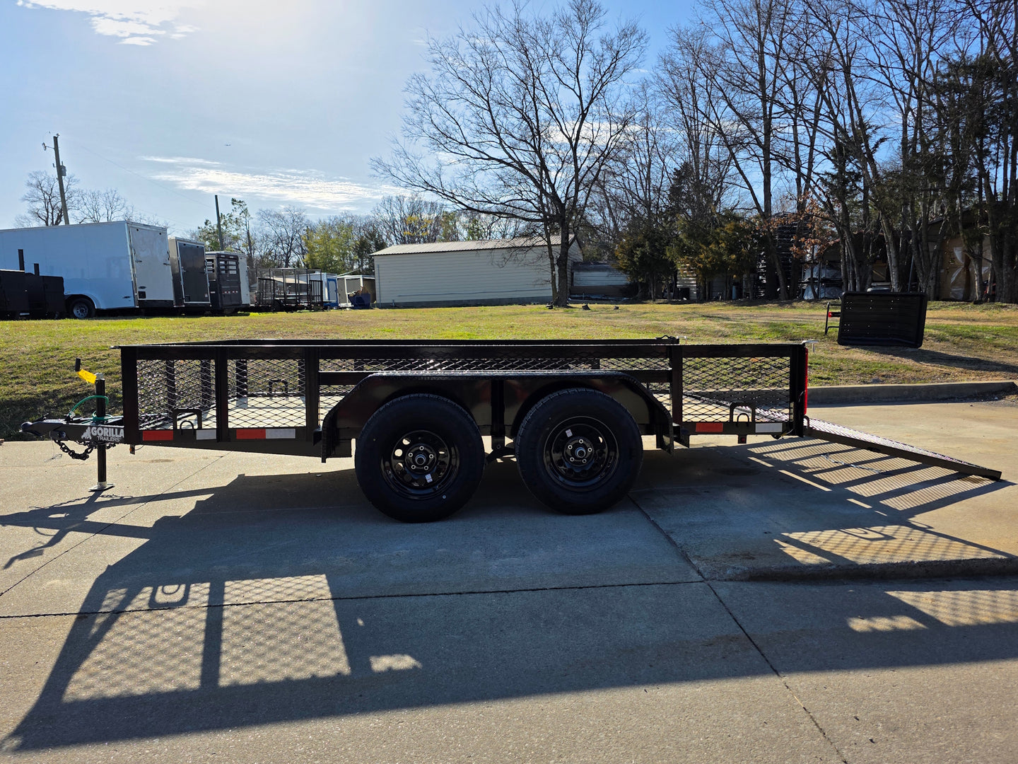 7' X 12' Straight Deck Utility Trailer 18IN Mesh Sides Double Axle 7K GVWR right side view picture with ramp down 