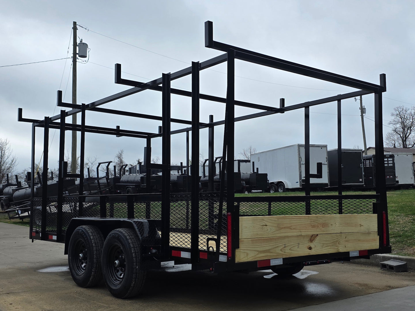 7x16 Straight Deck (2) 5200lb axles 2ft mesh 6ft ladder racks Back left angle picture 