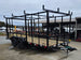 7x16 Straight Deck (2) 5200lb axles 2ft mesh 6ft ladder racks Front left angle picture 
