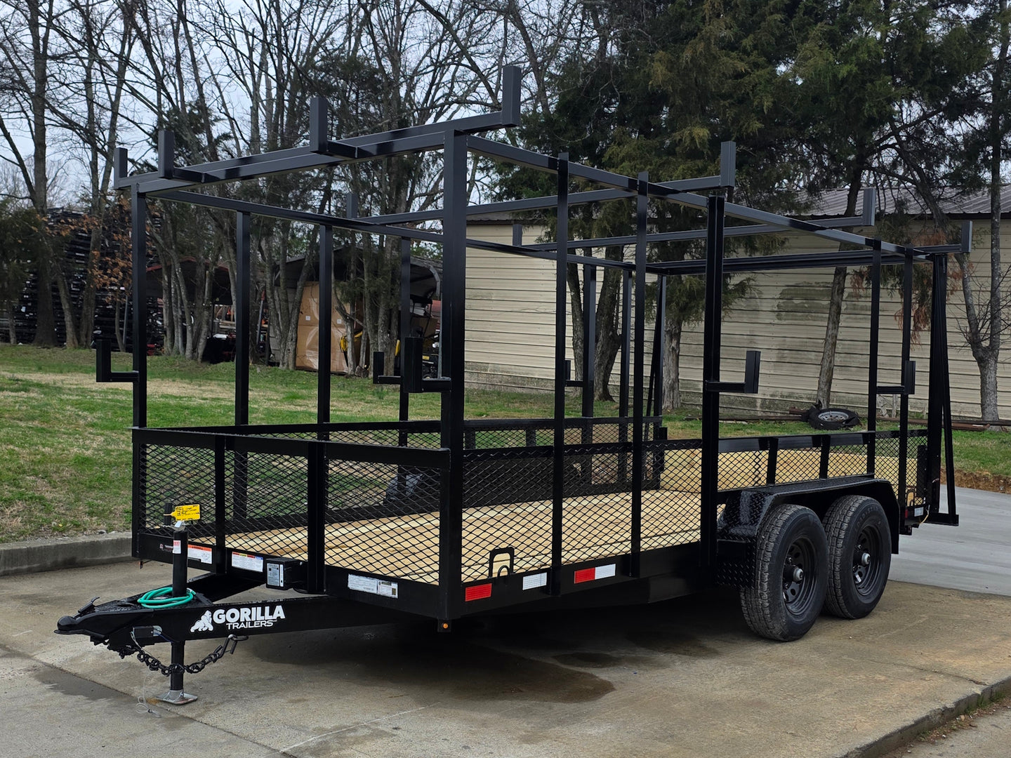 7x16 Straight Deck (2) 5200lb axles 2ft mesh 6ft ladder racks Front right angle picture 