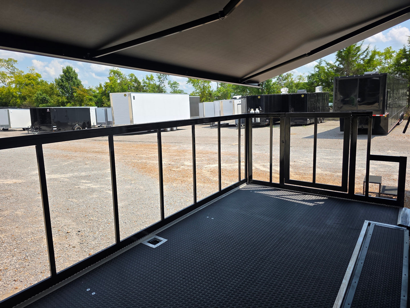 8.5' X 24' Black Custom Enclosed Trailer For Marketing and Showcase Events Side porch front right angle picture 