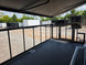 8.5' X 24' Black Custom Enclosed Trailer For Marketing and Showcase Events Side porch front right angle picture 