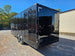 8.5' X 24' Black With Blackout Custom Stage Trailer With Awning Drivers Side Rear Angle Shot