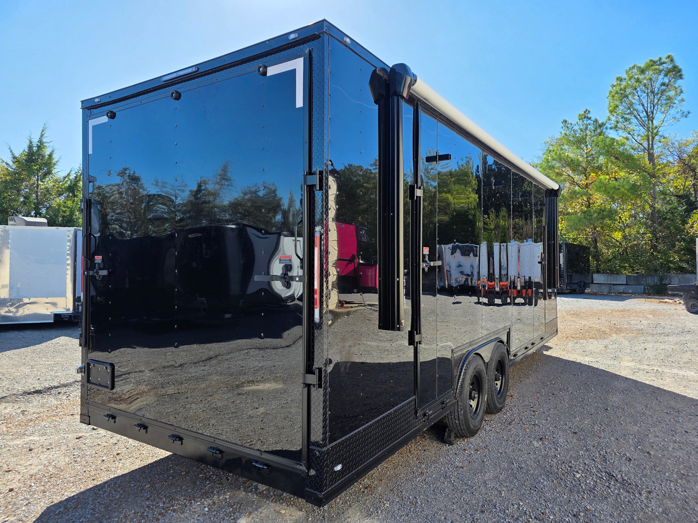 8.5' X 24' Black With Blackout Custom Stage Trailer With Awning Rear Passenger Side Angle 