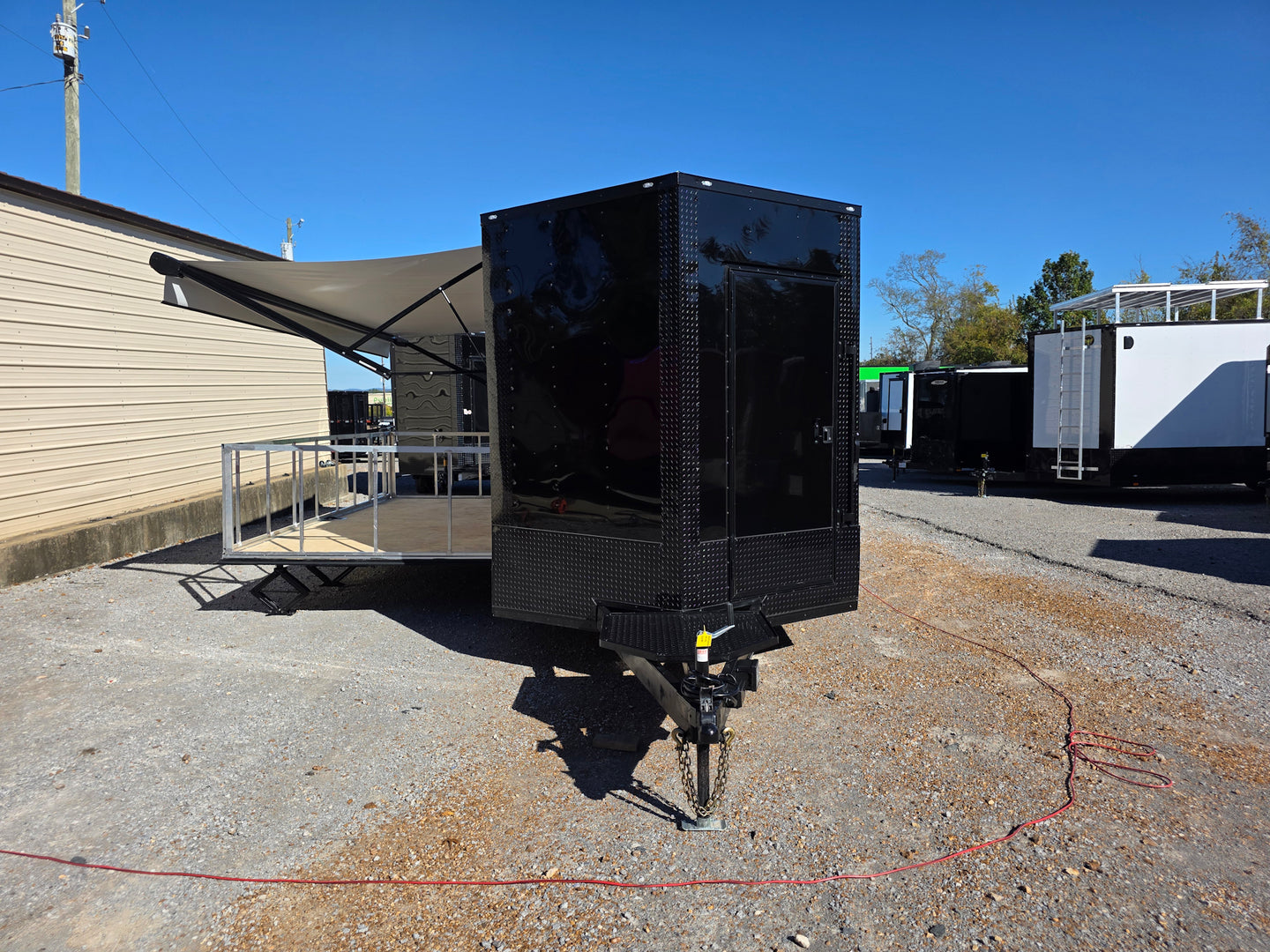 8.5' X 24' Black With Blackout Custom Stage Trailer With Awning Stage Down Awning Up Front View 