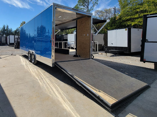 8.5' X 24' Cobalt Blue Stage & Event Marketing Concession Trailer Drivers Side Rear View with Stage out and rear ramp down