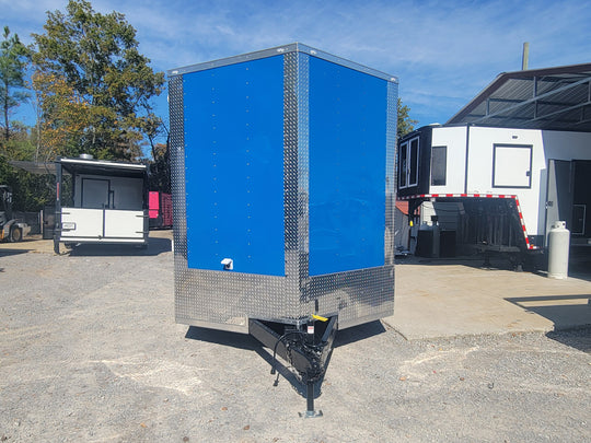 8.5' X 24' Cobalt Blue Stage & Event Marketing Concession Trailer Front Angle Trailer Closed