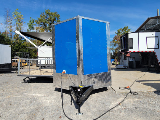 8.5' X 24' Cobalt Blue Stage & Event Marketing Concession Trailer front view with stage out 