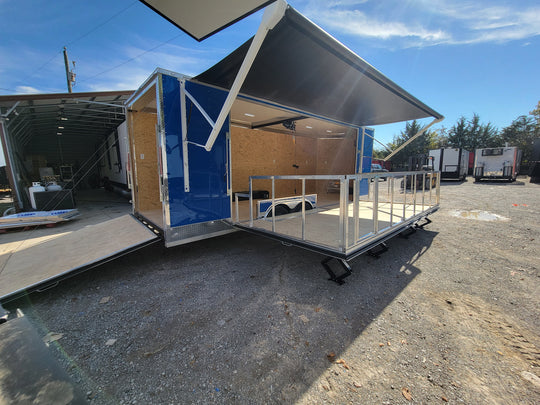 8.5' X 24' Cobalt Blue Stage & Event Marketing Concession Trailer Passenger Side  Stage Down Rear Angle View 