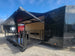 8.5' X 24' Custom Enclosed Stage Trailer Mobile Cigar Lounge Passenger Side Corner Shot Awning and Stage Extended.