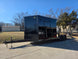8.5' X 24' Hybrid Trailer Black With Black Out Package 7K Axles front right angled view picture with ramp down 