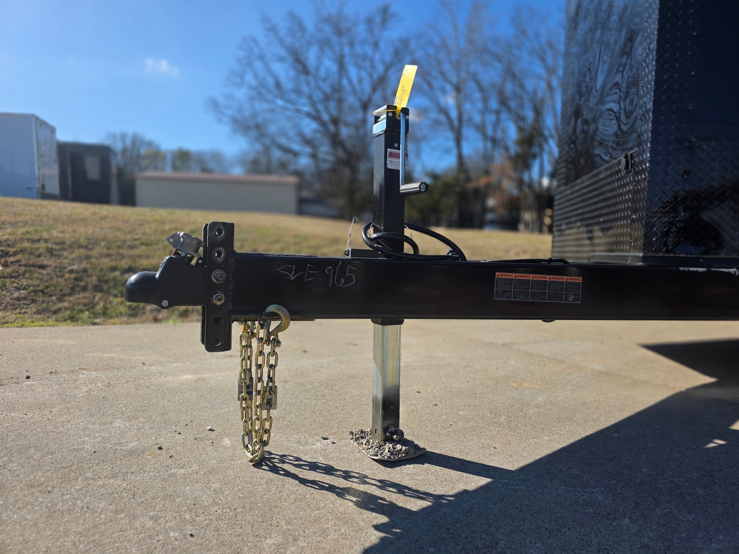 8.5' X 24' Hybrid Trailer Black With Black Out Package 7K Axles jack and chain view picture 
