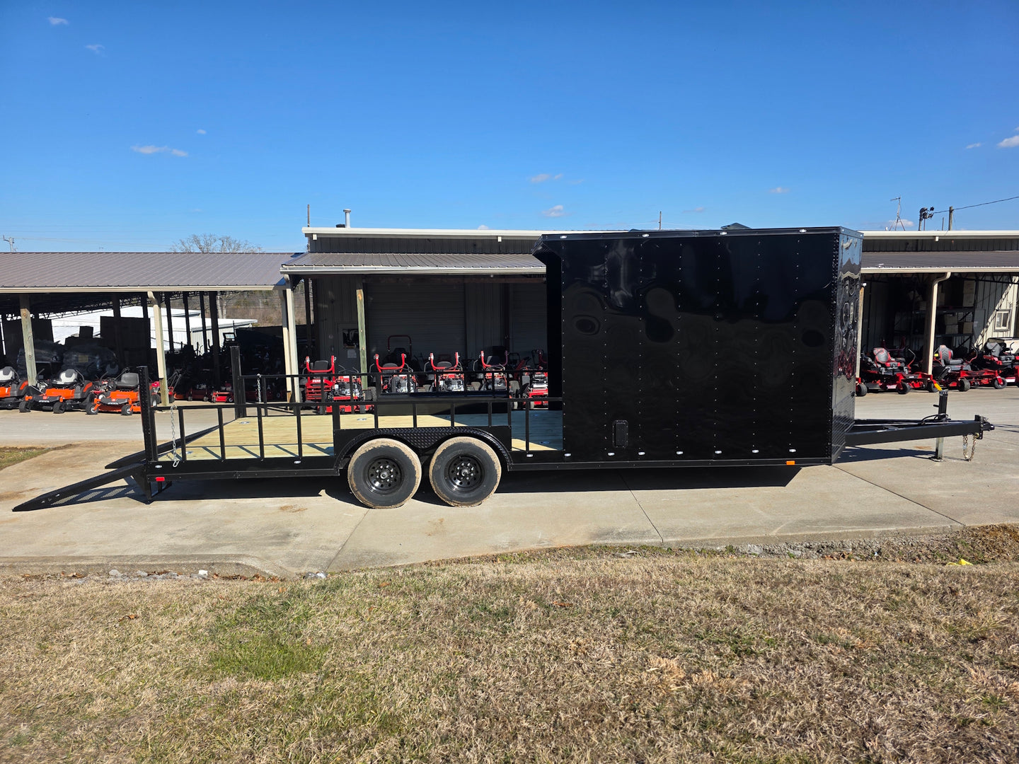 8.5' X 24' Hybrid Trailer Black With Black Out Package 7K Axles left side angled view picture with ramp down 
