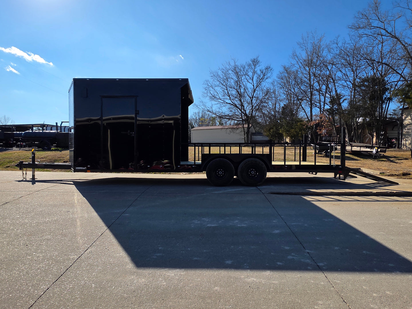 8.5' X 24' Hybrid Trailer Black With Black Out Package 7K Axles right side view picture with ramp down 