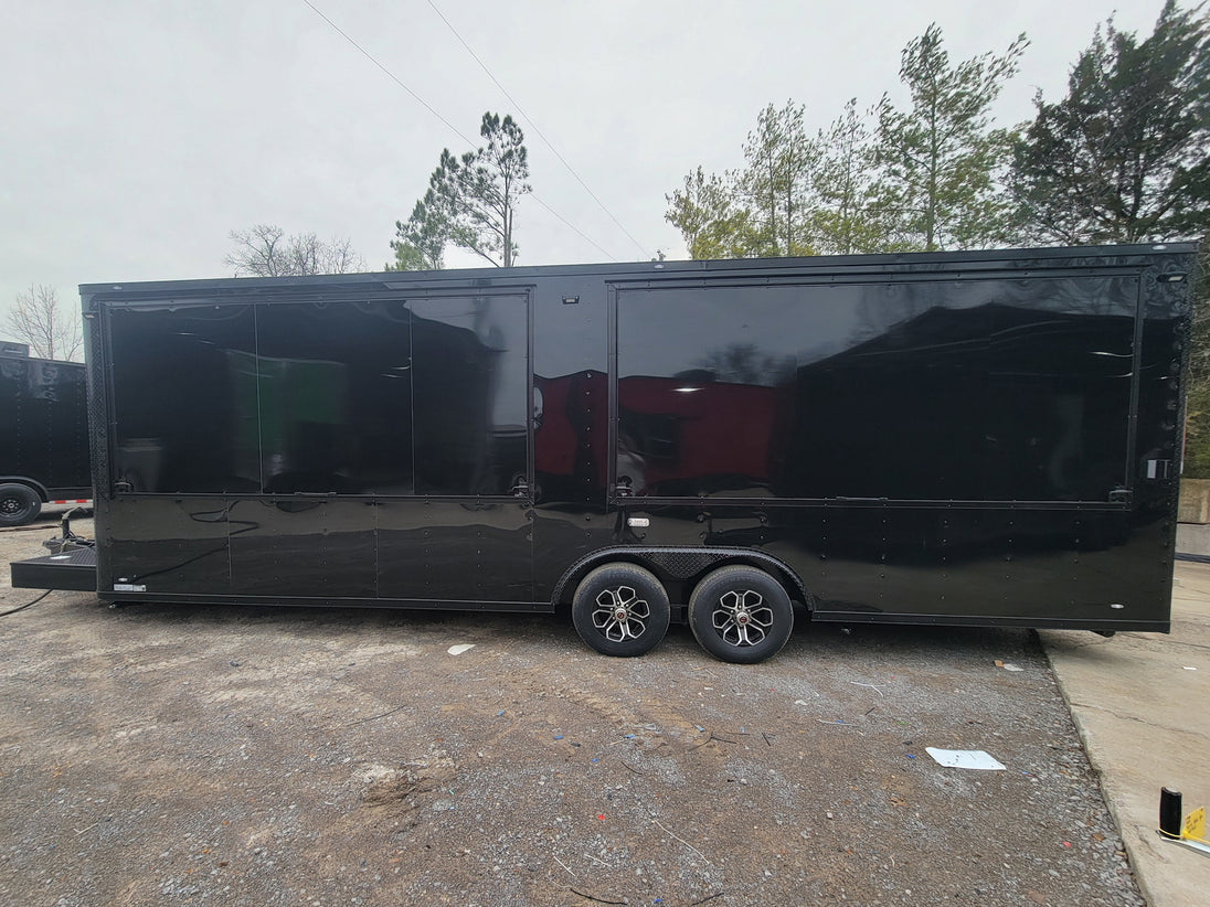 8.5' X 26' Custom Enclosed Merchandise and Marketing Trailer with Black Out Trim, lateral view.