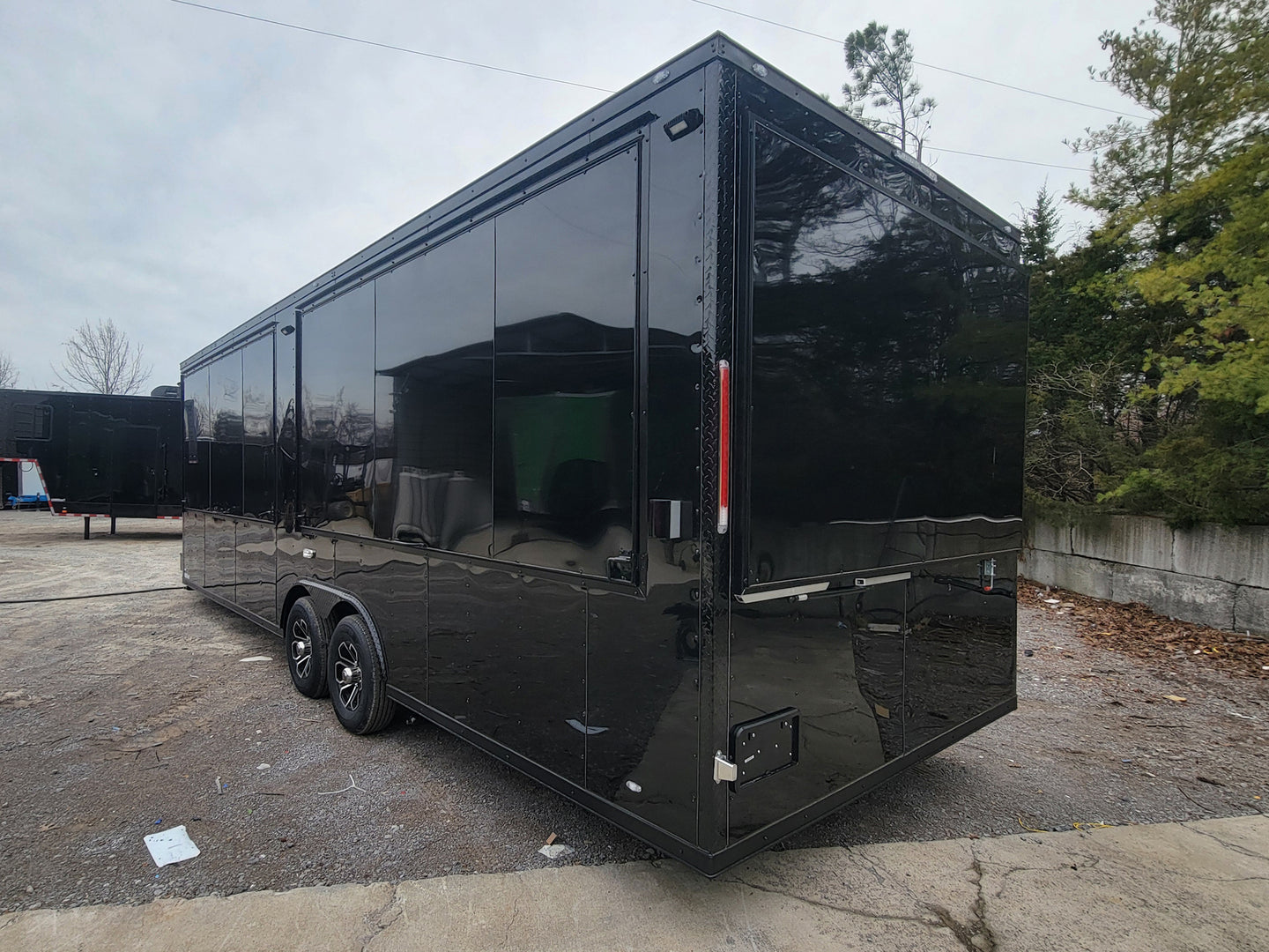 8.5' X 26' Custom Enclosed Merchandise and Marketing Trailer with Black Out Trim, Lateral View. 
