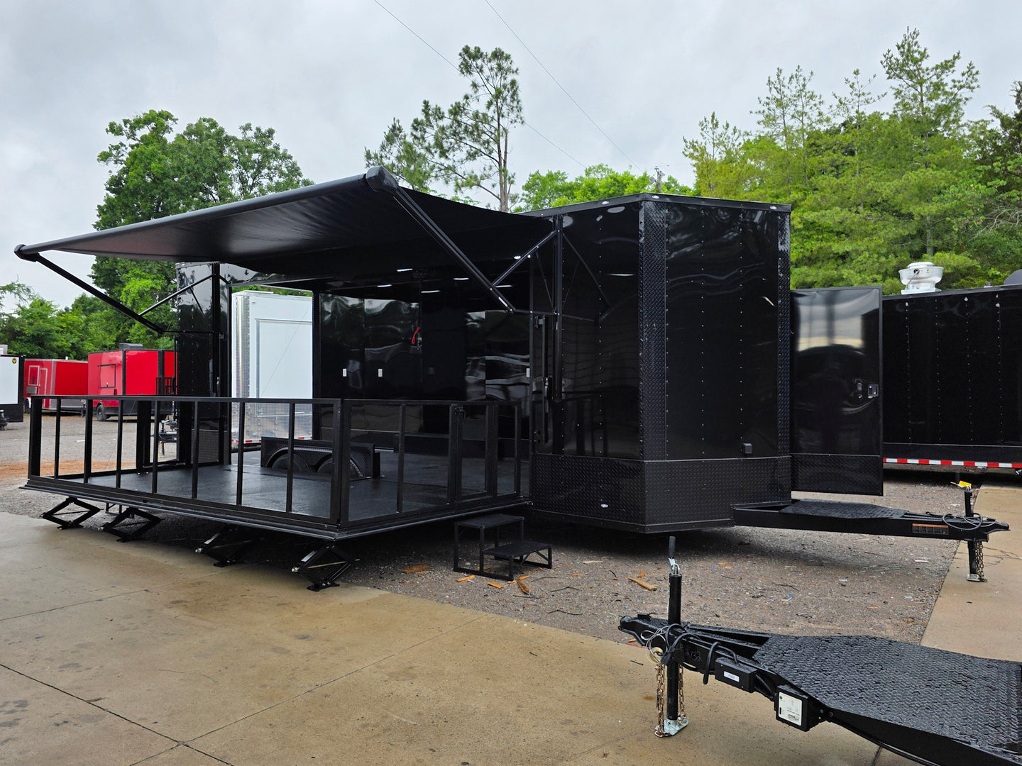 8.5'x24' Black Custom Event Stage Trailer w/ 16' Fold-Down Stage Open front left-angle picture 