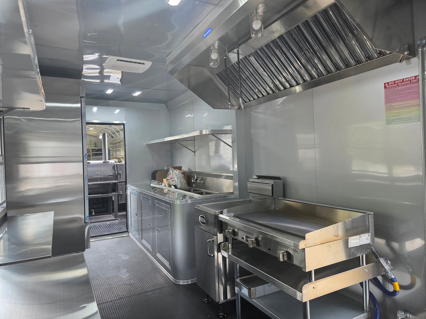8.5'x28' Black w/ Black out trim Concession Trailer with Porch Package Interior front left angle picture 