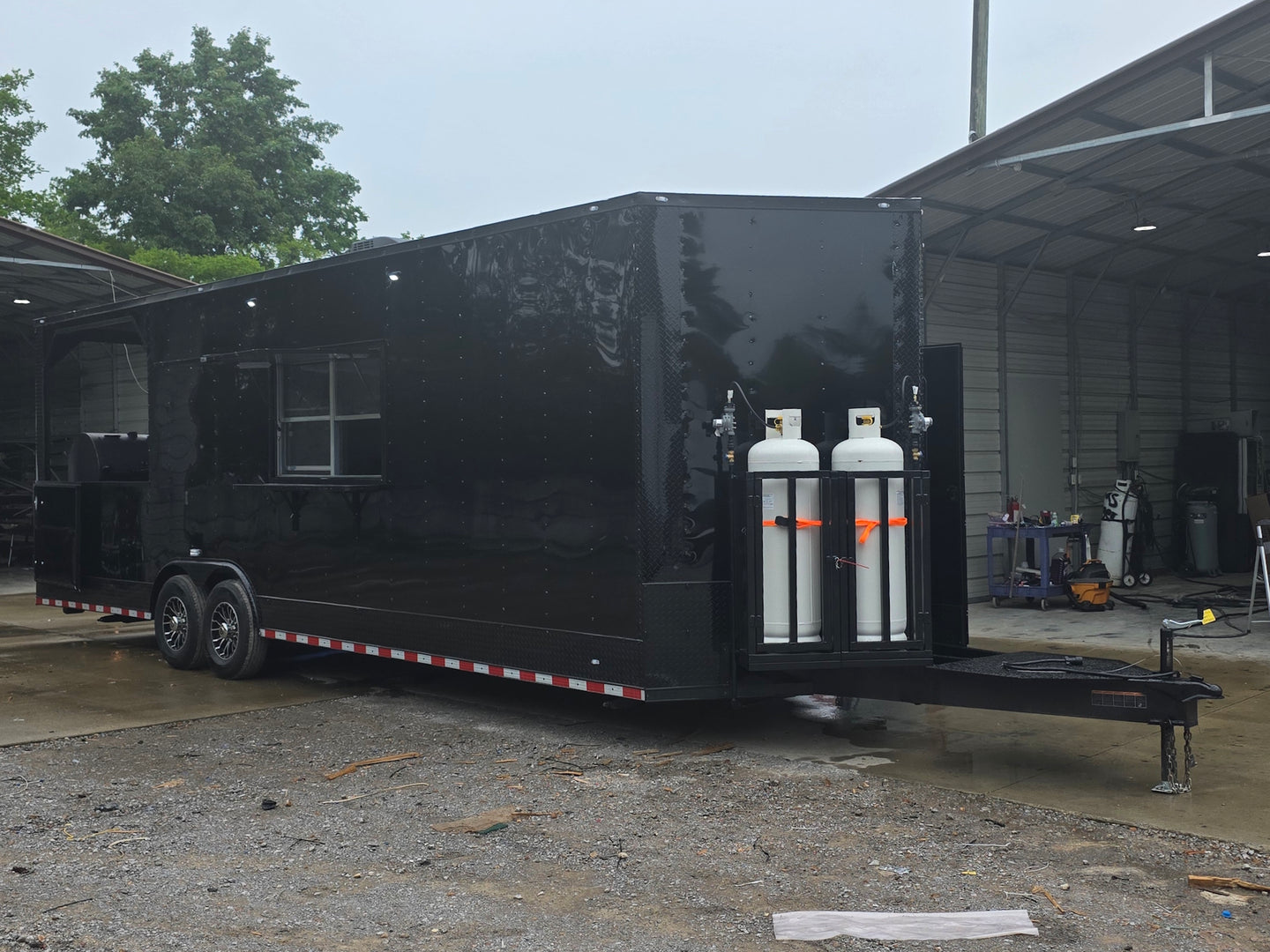 8.5'x28' Black w/ Black out trim Concession Trailer with Porch Package Open front left angle picture 