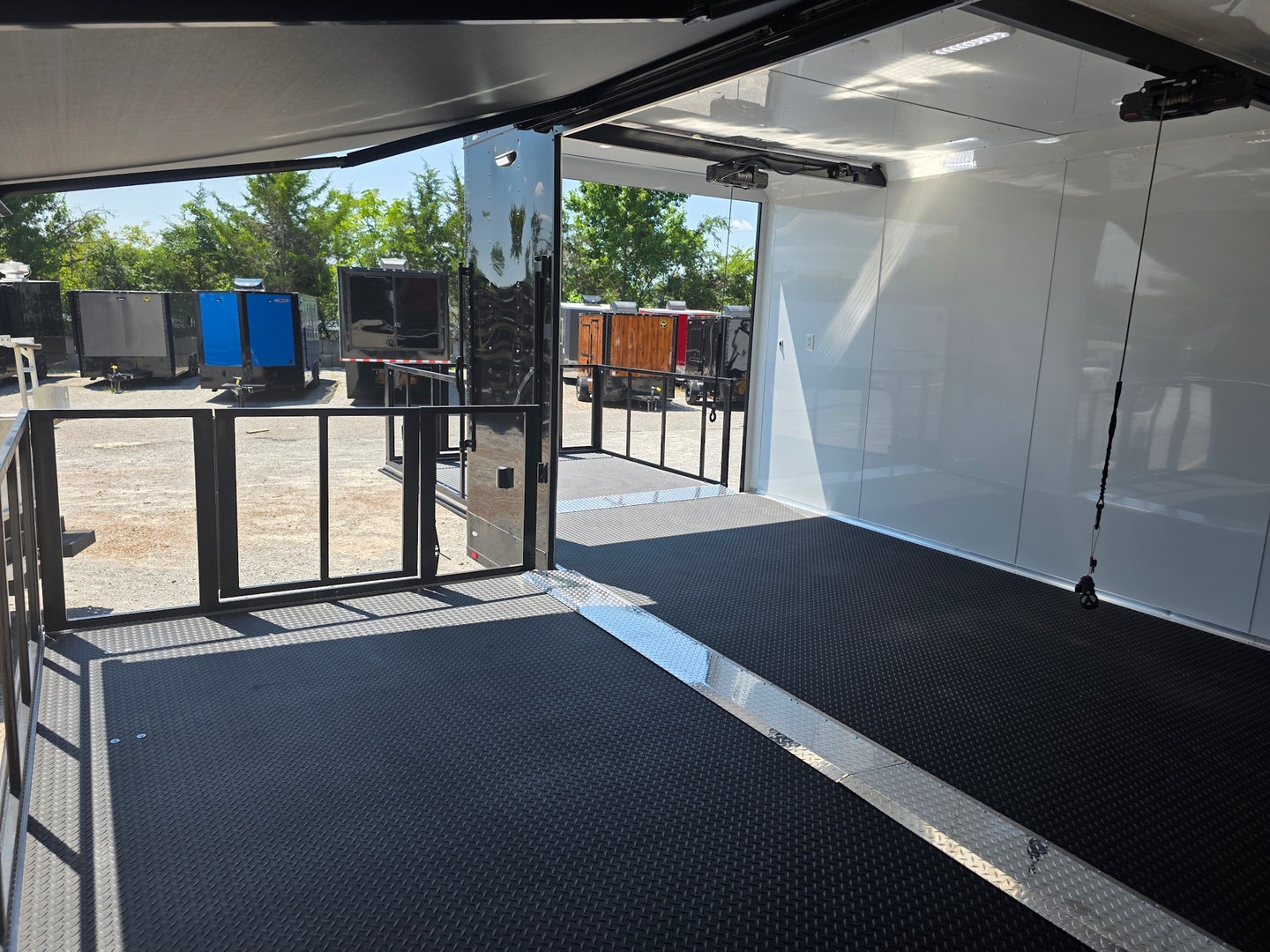 8.5x24 Black Stage trailer-34619 Side stage front left angle picture 