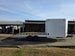 8.5x24 Hybrid White Enclosed V-Nose Trailer (2) 7000lb Axles left side view picture with ramp down 