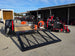 Ferris 5901940 SRSZ1 48" Stand On Mower 5x10 Utility Handheld Package rear left angled view picture with ramp down 
