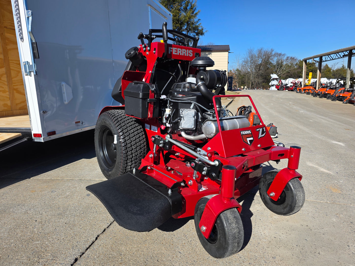 Ferris SRS Z1 36" 19HP 5901939 Kawasaki Stand-On Mower Handhelds Enclosed Trailer Bundle close up with ramp down view picture 