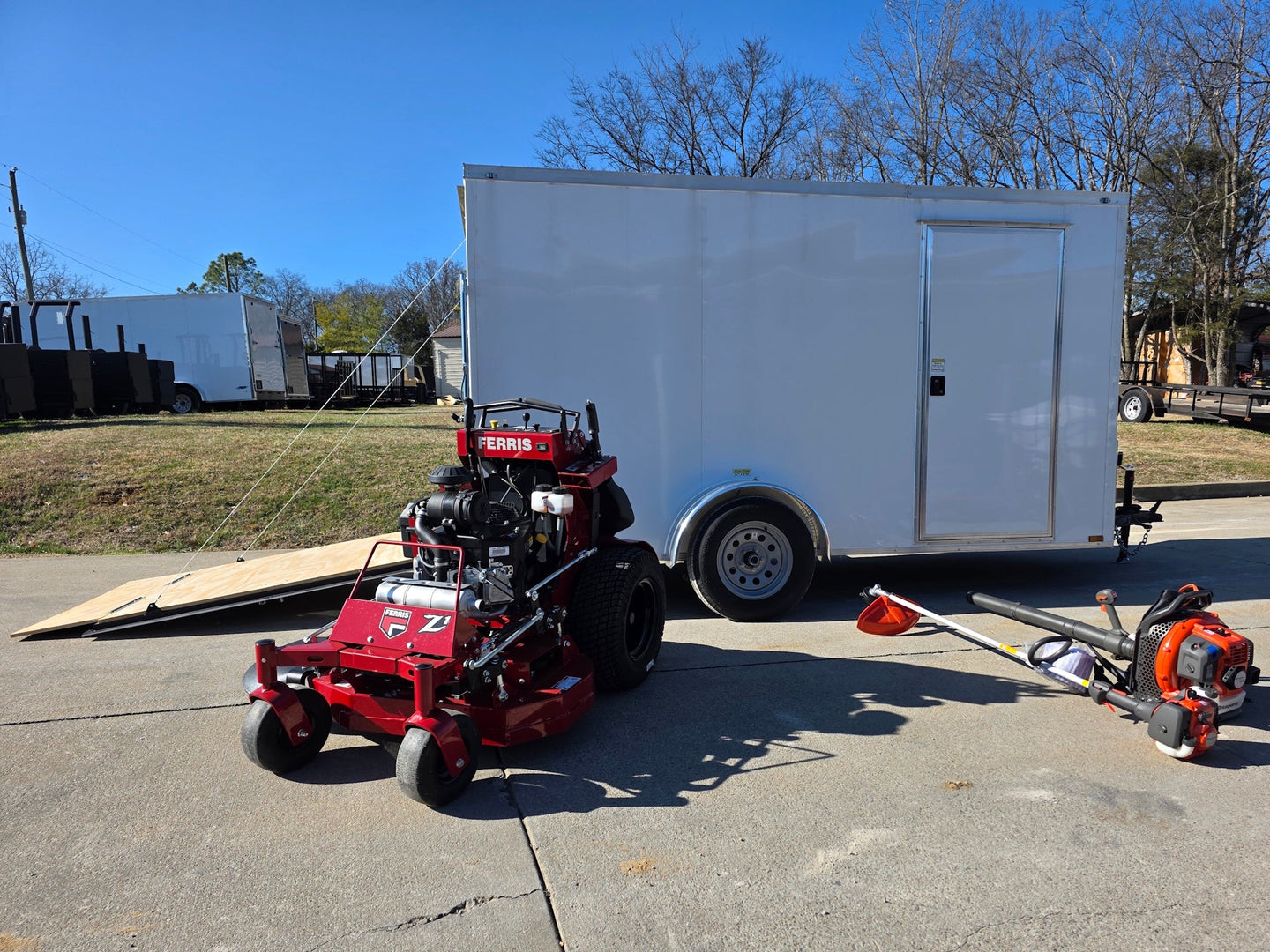 Ferris SRS Z1 36" 19HP 5901939 Kawasaki Stand-On Mower Handhelds Enclosed Trailer Bundle straight picture with ramp view down 