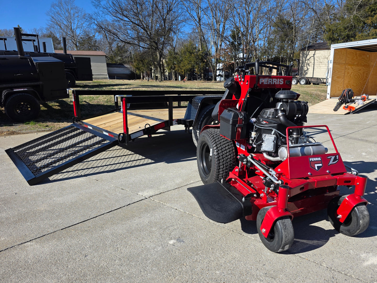 Ferris SRS Z1 36" 19HP Kawasaki 5901939 Stand-On Mower 5x10 Utility Trailer Package (Instant Rebate Included) left angled view with ramp down picture