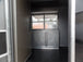 8.5' x 30' Black and Orange Porch Style Concession Food Trailer with Restroom