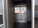8.5' x 30' Black and Orange Porch Style Concession Food Trailer with Restroom